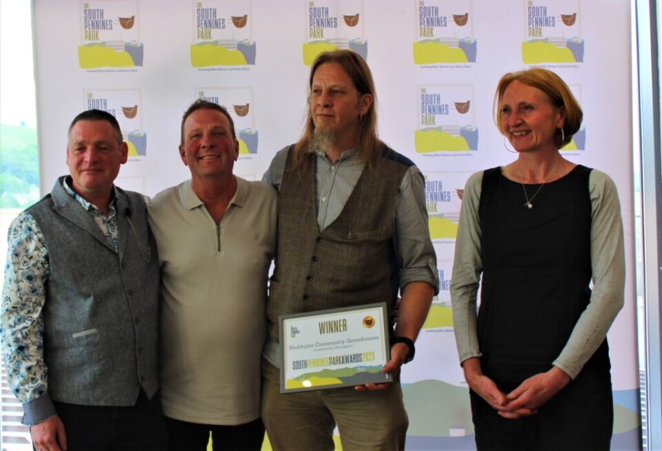 three men and a woman accepting an award for Stubbylee community garden